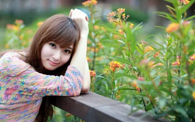 Asian Woman Leaning Wooden Railing Abstract Wallpaper 4K 2560x1600 An, Asian, Woman, Leaning, On, A, Wooden, Railing, Surrounded, Vibrant, Green, Plants, White, Ultrawide, QHD
