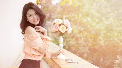 Smiling Asian Woman Poses Abstract Wallpaper 4K 2048x1152 A, Smiling, Asian, Woman, Poses, Outdoors, Beside, Table, Vase, Roses, Set, Against, White, Gray, Ultrawide, Full HD