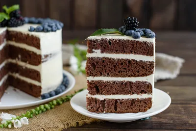 Rich Chocolate Layered Black/Dark Wallpaper 4K 5393x3600 A, Rich, Chocolate, Layered, Cake, With, White, Frosting, Topped, Fresh, Blackberries, Blueberries, Landscape, 4k