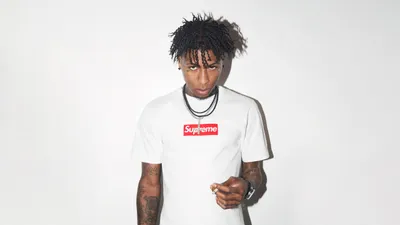 Dark Music Wallpaper Abstract Wallpaper 4K 5120x2880 Music, Artist, Standing, Against, A, White, Background, Wearing, Supreme, Shirt, Suitable, Desktop, Ultrawide, 4K