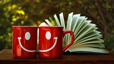 Golden Two Wallpaper Abstract Wallpaper 4K 2500x1407 Two, Red, Smiley-face, Mugs, Are, Placed, Side, By, Front, Open, Book, Fanned, White, Ultrawide, Full HD