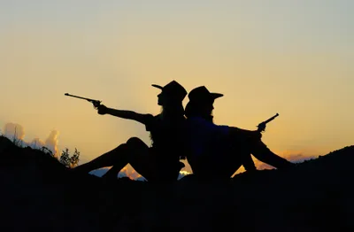 Serene Silhouette Wallpaper Nature Wallpaper 4K 3774x2470 Silhouette, Of, Two, Cowgirls, Sitting, Back-to-back, Each, Holding, Gun, Against, Vibrant, Sunset, Gray, Ultrawide, QHD