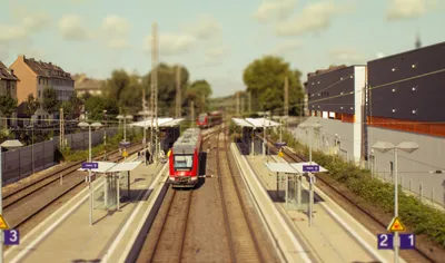 Tilt Shift Photograph Miniature Abstract Wallpaper 4K 4505x2661 A, Tilt-shift, Photograph, Of, Miniature, Train, Station, Showcasing, Vibrant, Trains, Along, Tracks, White, Gray, Ultrawide, 4k