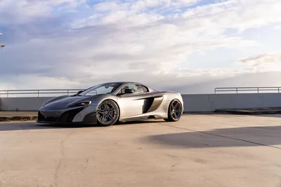 Silver Mclaren Sports Car Rooftop Cars Wallpaper 4K 9504x6336 Silver, Mclaren, Sports, Car, Parked, On, A, Rooftop, Under, Dramatic, Clouds, Ultra, White, Gray, Landscape, 4k