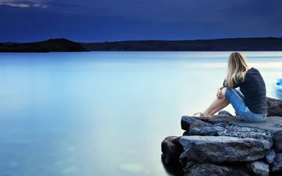 Woman Sits Contemplatively Rocky Shore Nature Wallpaper 4K 1920x1200 A, Woman, Sits, Contemplatively, On, Rocky, Shore, Overlooking, Calm, Blue, Lake, Under, Brown, Ultrawide, Full HD