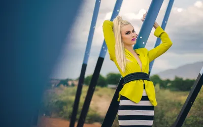 Blonde Australian Rapper Nature Wallpaper 4K 2880x1800 A, Blonde, Australian, Rapper, And, Singer, Poses, Confidently, Outdoors, Dressed, Vibrant, Yellow, Brown, Gray, White, Ultrawide, QHD