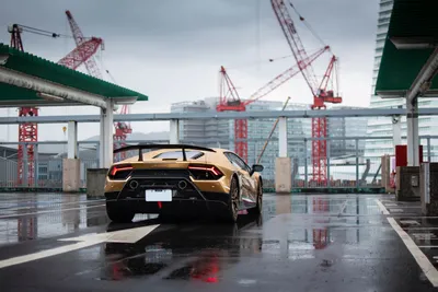 Gold Wet Rooftop World Wallpaper 4K 5700x3800 Rear, View, Of, A, Gold, Lamborghini, On, Wet, Rooftop, Parking, Deck, Cranes, Gray, White, Landscape, 4k