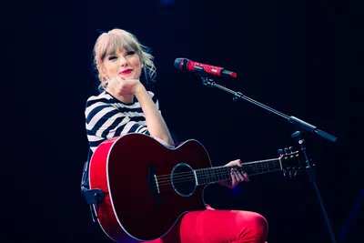 Vibrant Taylor Swift Smiling While Abstract Wallpaper 4K 1800x1200 A, Vibrant, Hd, Wallpaper, Featuring, Taylor, Swift, Smiling, While, Holding, Guitar, Embodies, Red, White, Landscape