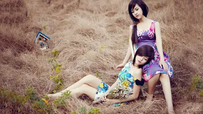 Vivid Two Wallpaper Animals Wallpaper 4K 1920x1080 Two, Women, In, Floral, Dresses, Are, Sitting, And, Lying, Down, Dry, Grass, Gray, Ultrawide, Full HD