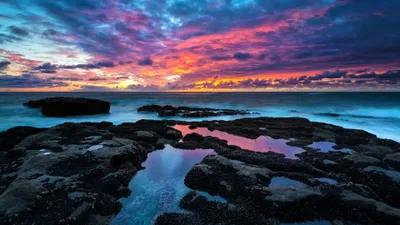 Sunset Ocean Vibrant Nature Wallpaper 4K 3840x2160 Sunset, Over, The, Ocean, With, Vibrant, Pink, And, Purple, Clouds, Reflecting, Rocky, Gray, Brown, Ultrawide, 4K