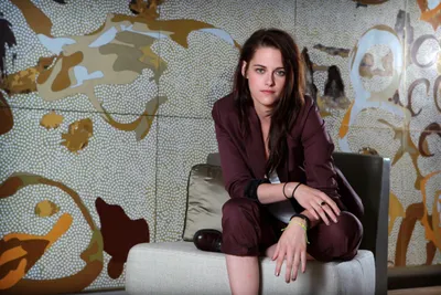 Vibrant Confident Wallpaper Abstract Wallpaper 4K 4444x2970 A, Confident, Kristen, Stewart, Sits, Casually, On, Couch, Dressed, Stylish, Attire, Against, Gray, Landscape, 4K