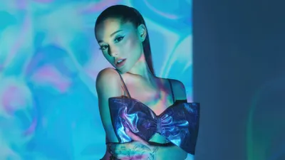 Ariana Grande Poses Shimmering Outfit Abstract Wallpaper 4K 5120x2880 Ariana, Grande, Poses, In, A, Shimmering, Outfit, With, Vibrant, Blue, Purple, Lighting, Yellow, Ultrawide, 4k