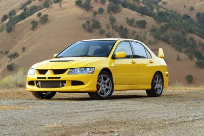 Vibrant Yellow Mitsubishi Abstract Wallpaper 4K 3000x2000 A, Vibrant, Yellow, Mitsubishi, Lancer, Evolution, Parked, On, Gravel, Surface, Picturesque, Backdrop, Gray, Landscape, QHD